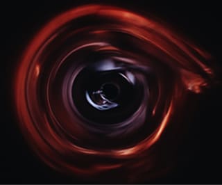 Black hole effect in online counselling - Photo of a circular swirl of red against a dark background