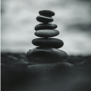 Black and white picture of rocks stacked on top of one another to create a tower.